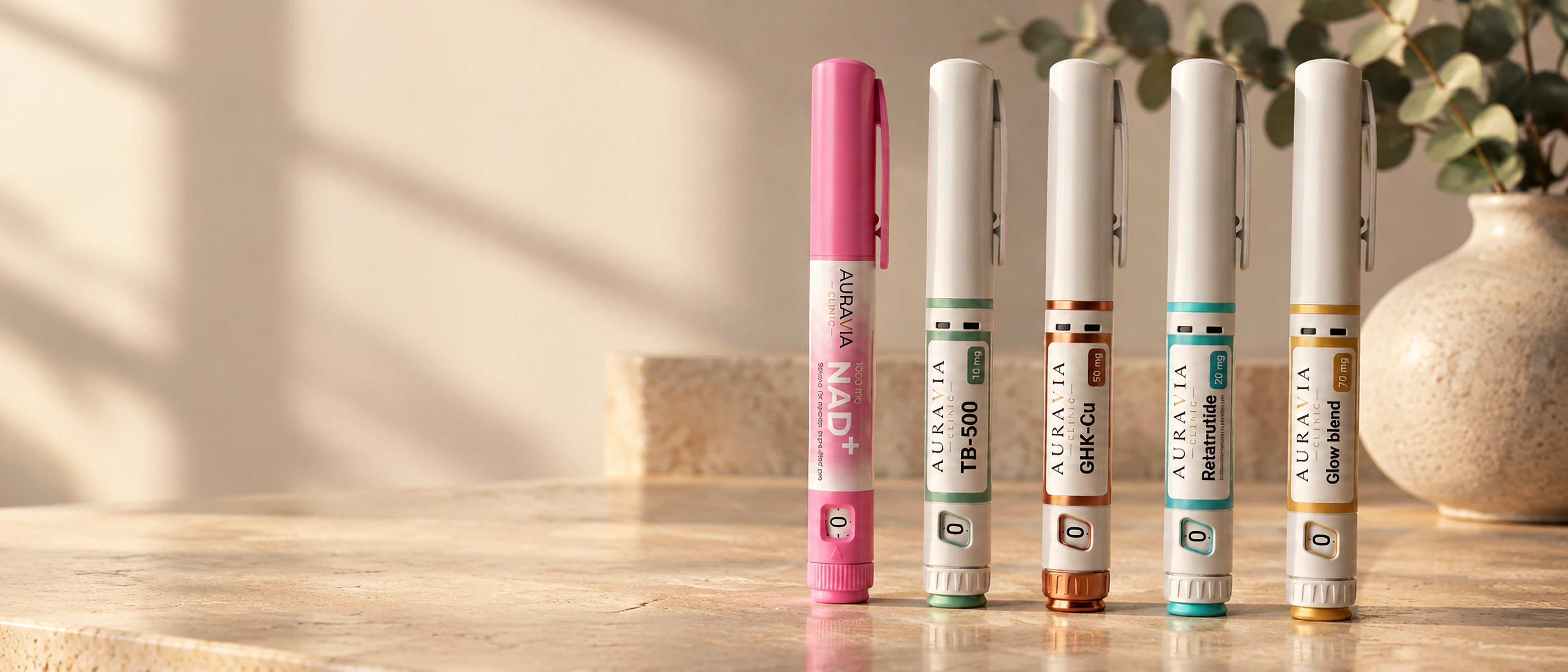 Row of AuraVia pre-filled research pens on a marble shelf in warm light
